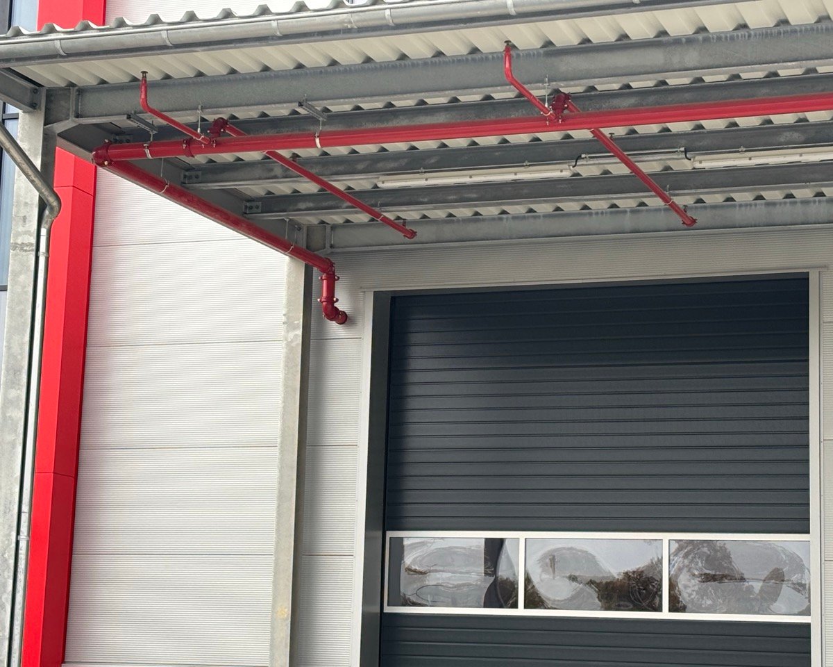 Gesamtansicht des Dachüberstands in Bremerhaven nach Abschluss der Reparatur, mit dem Sprinkler-Rohrsystem.